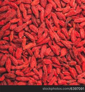 The red dried goji berries as a background. The Goji berries