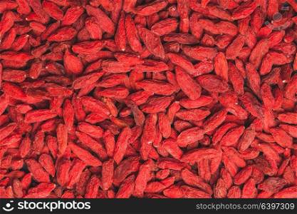 The red dried goji berries as a background. The Goji berries