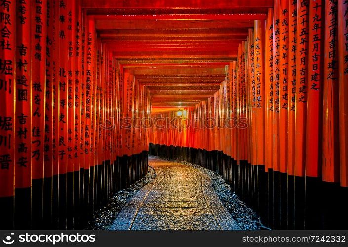 The red torii gates walkway at fushimi inari taisha shrine in Kyoto, Japan.