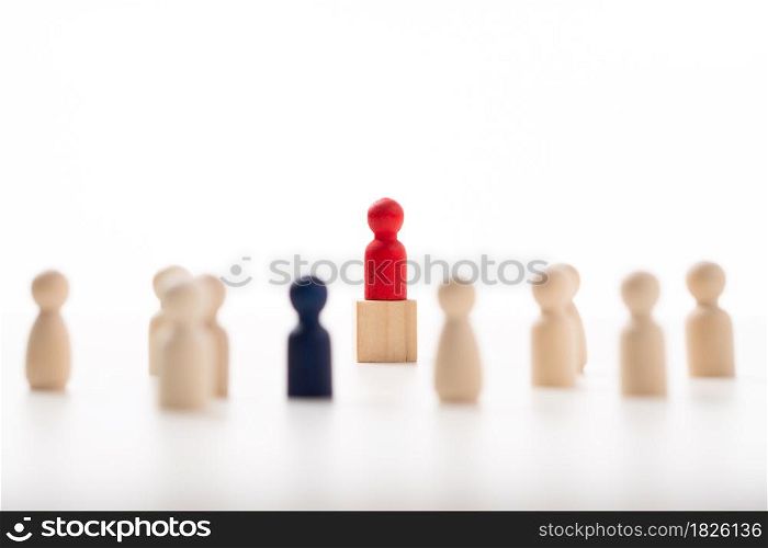 The red wooden figure standing on the box show influence and empowerment. Concept of business leadership for leader team, successful competition winner and Leader with influence
