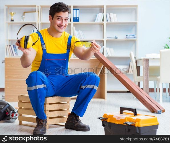 The repairman carpenter working with wooden plank planks. Repairman carpenter working with wooden plank planks