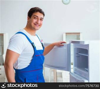 The repairman contractor repairing fridge in diy concept. Repairman contractor repairing fridge in DIY concept