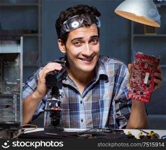 The repairman trying to repair laptop with miscroscope. Repairman trying to repair laptop with miscroscope