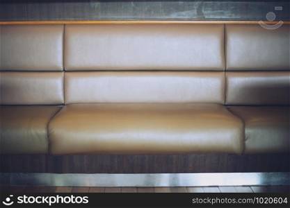 The retro Big Sofa from brown leather in fast food shop