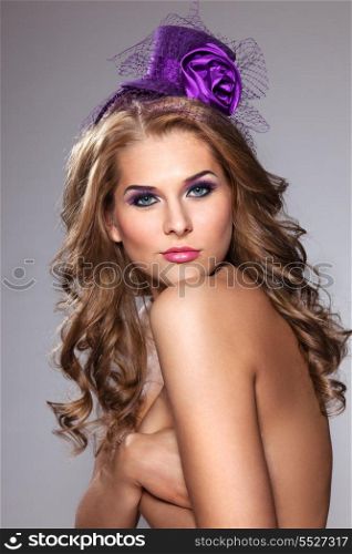 The retro photo of a cute girl in a vintage hat with a sensualy closed eyes covered with violet makeup.