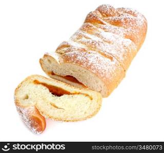 The rich ruddy roll is strewed by powdered sugar with a stuffing from dried apricots on a white background