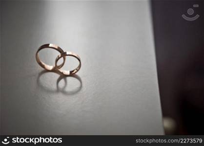 The rings of the newlyweds are rolling on the table.. The rings of the newlyweds standing on the end of the table 4259.