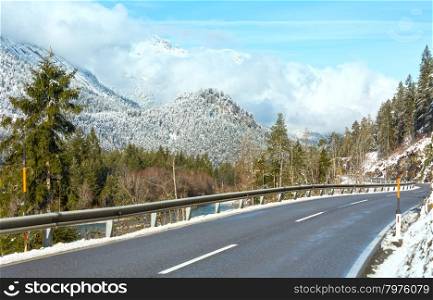 The road along the river and snow-covered mountain slopes (Austria, Tirol).