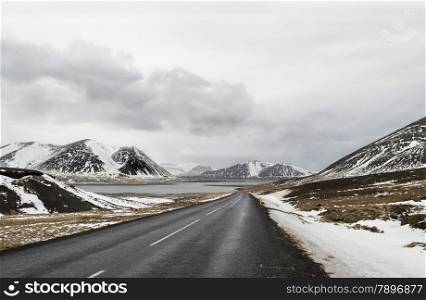 the road to snaefellsne on the island iceland with lake and mountains in winter