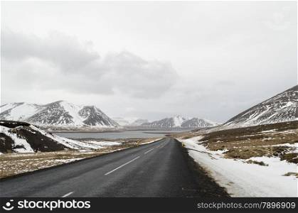 the road to snaefellsne on the island iceland with lake and mountains in winter