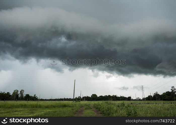 The road to the field with the rain clouds are falling.