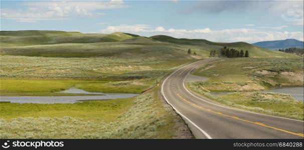 The road winds around the bend at Elk Antler Creek in Wyoming
