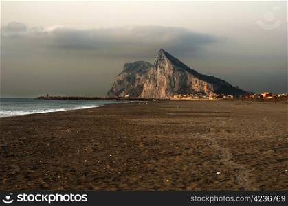 The rock of Gibraltar and the sea. Early morning. View from Spain beach