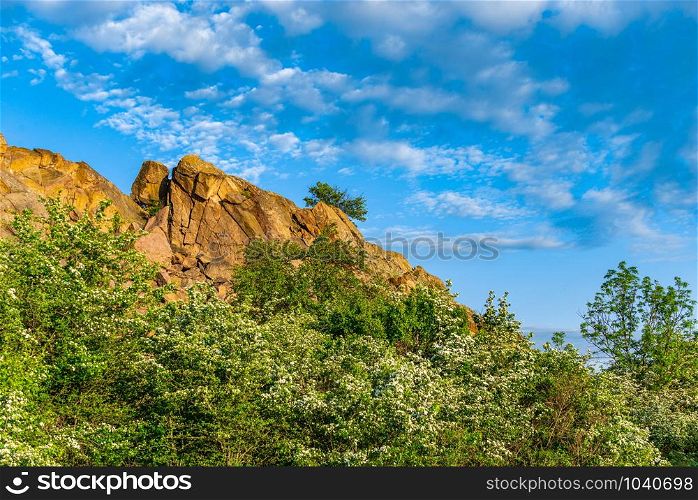 The rocky banks of the Southern Bug River near the village of Migiya in Ukraine on a sunny summer day. The beauty of nature in Migiya, Ukraine