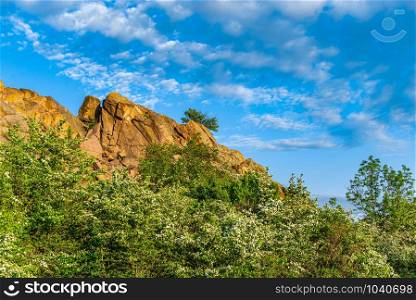 The rocky banks of the Southern Bug River near the village of Migiya in Ukraine on a sunny summer day. The beauty of nature in Migiya, Ukraine