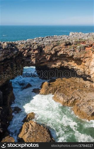 The rocky coastline of Cascais is famous for the cave named, The jaws of the devil or The gates of hell, Portugal.