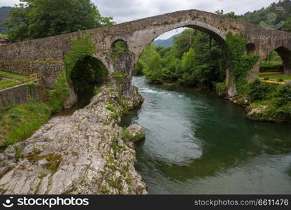 the Roman bridge built in the late 13th century over the Sella River in Cangas de Onis, Asturias, Spain.