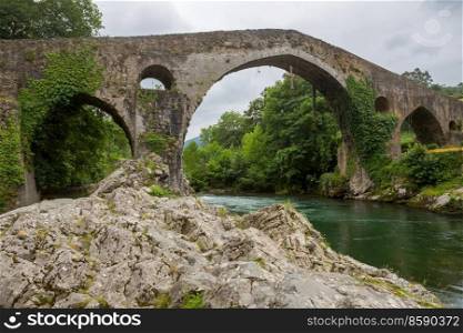 the Roman bridge built in the late 13th century over the Sella River in Cangas de Onis, Asturias, Spain.
