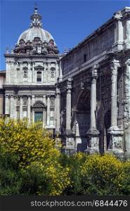 The Roman Forum - Rome Italy. The Arch of Septimius Severus and the church of Santi Luca-e-Martina. The arch is a triumphal arch dedicated in AD 203 to commemorate the Parthian victories of Emperor Septimius Severus and his two sons.. Roman Forum - Rome - Italy
