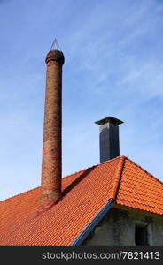 The roof and chimney with blue sky