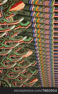 The roof beams over a covered walkway at the Gyeongbokgung Palace complex form a pattern of bright colors and forms.