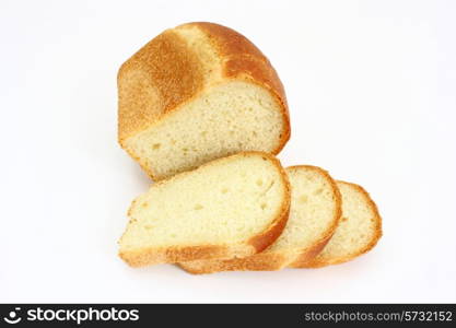 The ruddy long loaf of bread with the fried crust is isolated on a white background