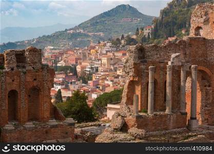 The Ruins of Ancient Greek theatre and Old Town of Taormina in sunny day, Sicily, Italy. Aerial view of Taormina, Sicily, Italy