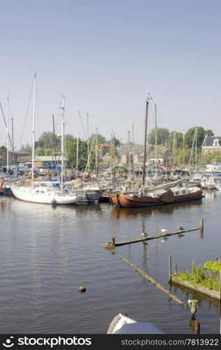 The rural harbour of Spaarndam, the Netherlands, where the luxury yachts are moored on a summer afternoon