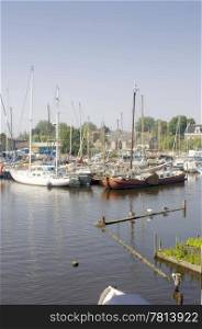 The rural harbour of Spaarndam, the Netherlands, where the luxury yachts are moored on a summer afternoon