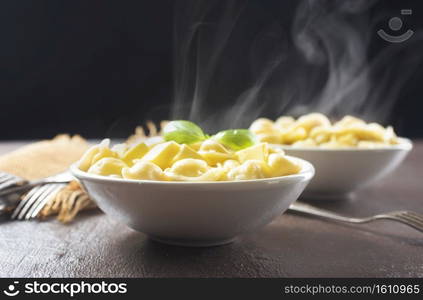 The Russian national dish - Pelmeni. Dumplings with meat, spiced with pepper  and butter