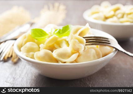 The Russian national dish - Pelmeni. Dumplings with meat, spiced with pepper  and butter