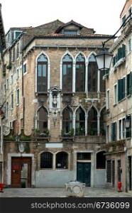 The rustic facade of an apartment building, Venice, Italy