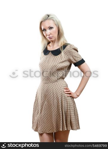 The sad girl in a beige dress on a white background