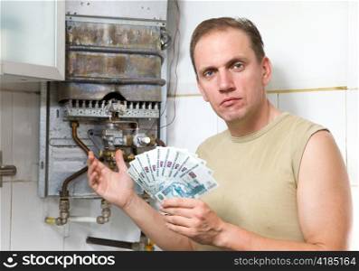 The sad man counts money for repair of a gas water heater
