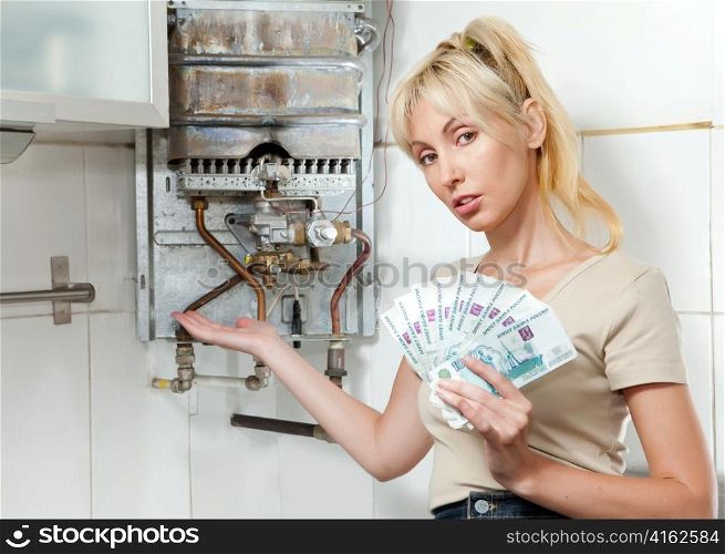 The sad woman the housewife counts up money for repair of a gas water heater
