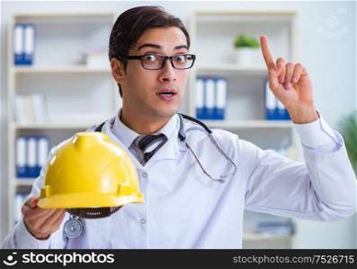The safety doctor advising about wearing hard hat. Safety doctor advising about wearing hard hat