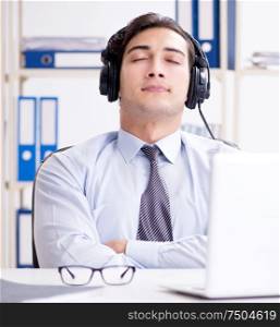The sales assistant listening to music during lunch break. Sales assistant listening to music during lunch break