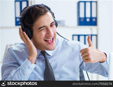 The sales assistant listening to music during lunch break. Sales assistant listening to music during lunch break