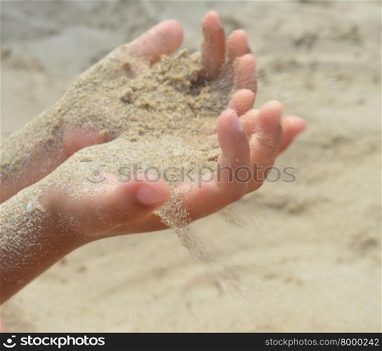 The sand flows out of the hands