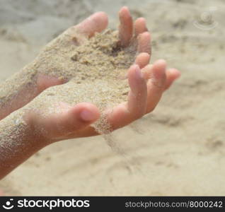 The sand flows out of the hands