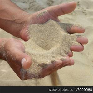 The sand flows out of the palms