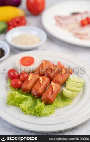 The sausage is put on a white plate with chili, tomatoes, cucumbers and salad greens.