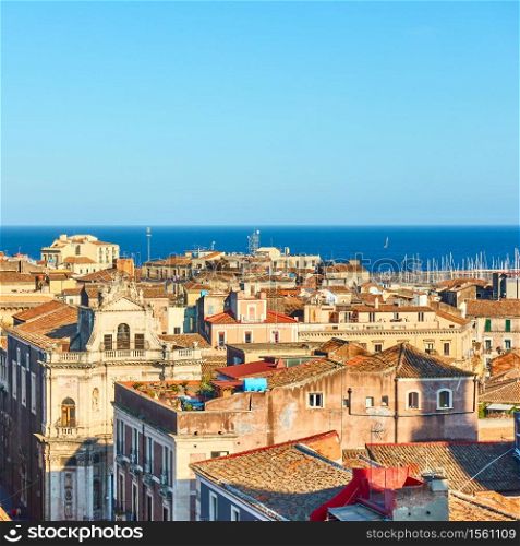 The sea and roofs of the old town of Catania in Sicily, Italy