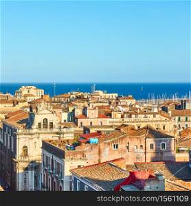 The sea and roofs of the old town of Catania in Sicily, Italy