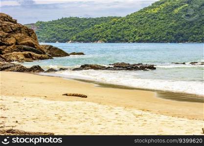 The sea between the beach, rocks and fully preserved rainforest in Trindade, Paraty district in Rio de Janeiro. The sea between the beach, rocks rainforest