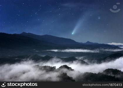 The sea of mist at night in the forest in the sky with meteors.. Meteors in forest.