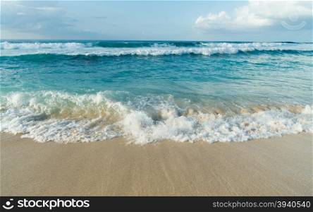 The sea rushes up meeting the sand on Oahu Island in the Pacific Ocean of North America