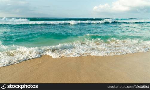 The sea rushes up meeting the sand on Oahu Island in the Pacific Ocean of North America