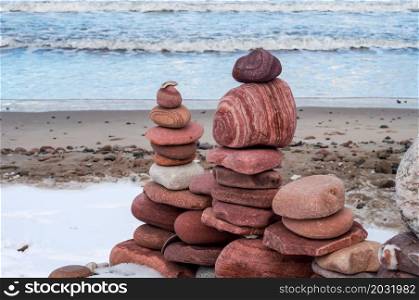 The sea stones are stacked beautifully. Zen and peaceful on the seashore. A pyramid of stones.. A pyramid of stones. The sea stones are stacked beautifully. Zen and peaceful on the seashore.