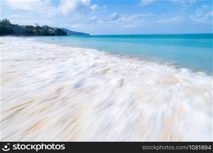 the sea wave splay white foam on the sand at the beach Phuket sea Thailand wide angle low speed shutter shot